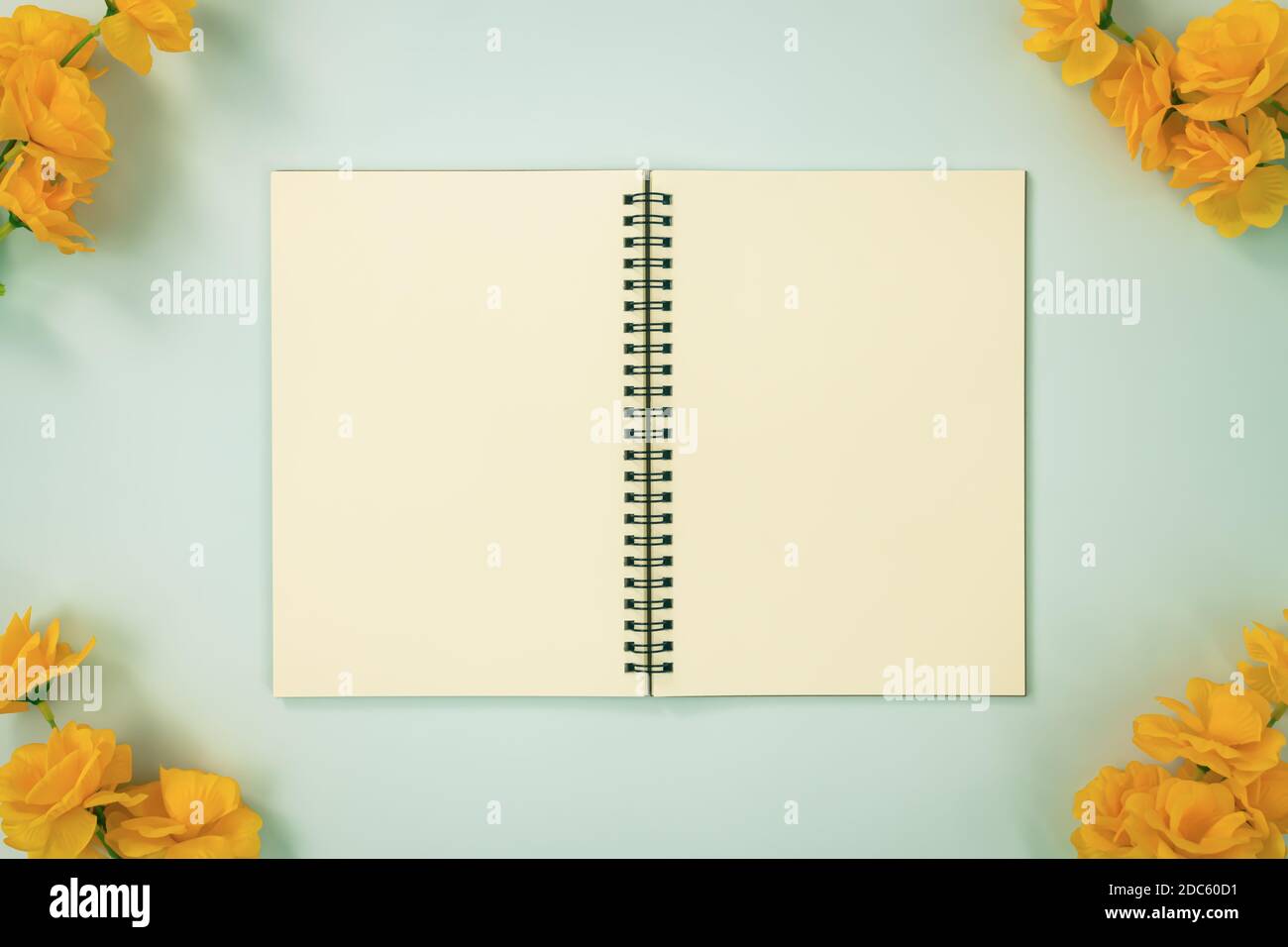 Download Top Table Spiral Notebook Or Spring Notebook Mockup In Unlined Type On Center Frame And Yellow Flowers At Corner On Blue Pastel Minimalist Background Stock Photo Alamy