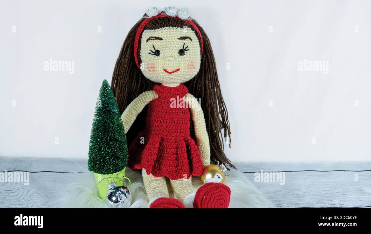 Brunette doll and christmas mini tree decoration Stock Photo