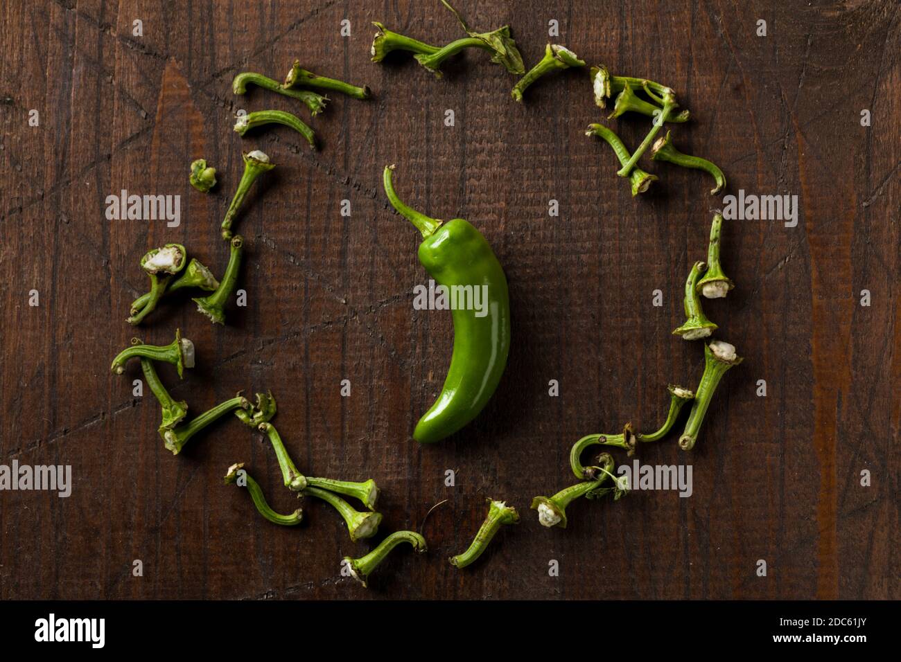 Green Friggitello Chili Pepper with Scattareed Petioles on Wooden Surface Stock Photo