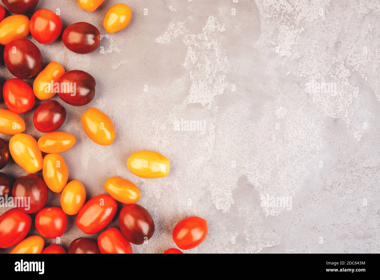 Cherry tomatoes on gray marble background. Copyspace. Stock Photo