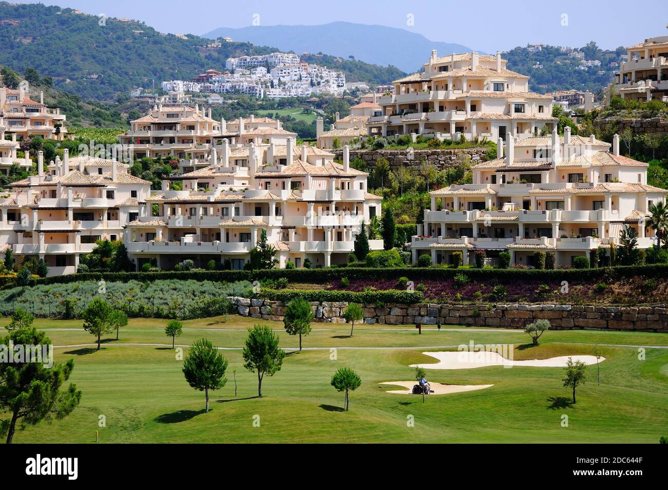 View across El Higueral Golf Course towards the apartment blocks on the hillside, Benahavis, Spain. Stock Photo
