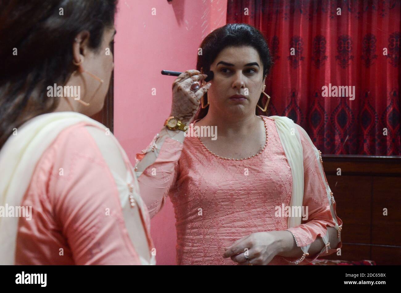 19 November 2020, Pakistan, Peshawar: Transwoman Zeeshan Khan is putting make-up on in her apartment. In September, the 26-year-old had lost a friend who was killed. (to dpa: 'Transgender in Pakistan lament hate and violent crime') Photo: Hasnain Ali/dpa Stock Photo