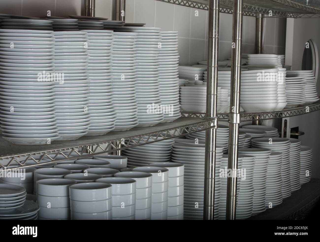 Utensils on metal rack in commercial kitchen Stock Photo - Alamy