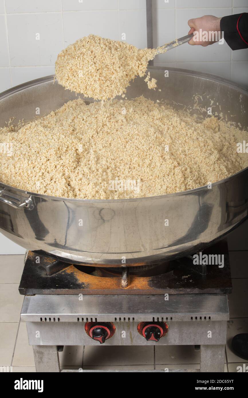 A chef cooking rice at a commercial kitchen Stock Photo Alamy