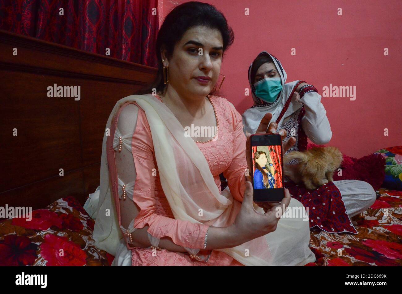 Peshawar, Pakistan. 19th Nov, 2020. Transwoman Zeeshan Khan (l) shows a picture of her friend Gul Panra. In September 2020 her friend Panra was killed. (to dpa: 'Transgender in Pakistan lament hate and violent crime') Credit: Hasnain Ali/dpa/Alamy Live News Stock Photo