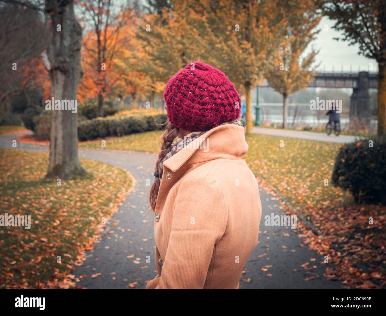A woman in fashionable autumn clothing in Avenham Park, Preston surrounded by fall colours Stock Photo