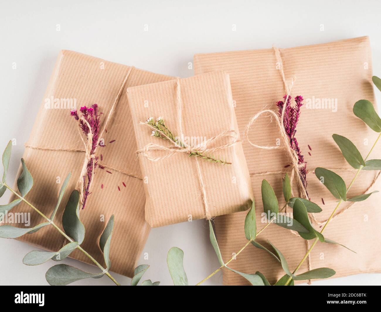 Gift boxes wrapped in craft paper with dried flowers Stock Photo - Alamy