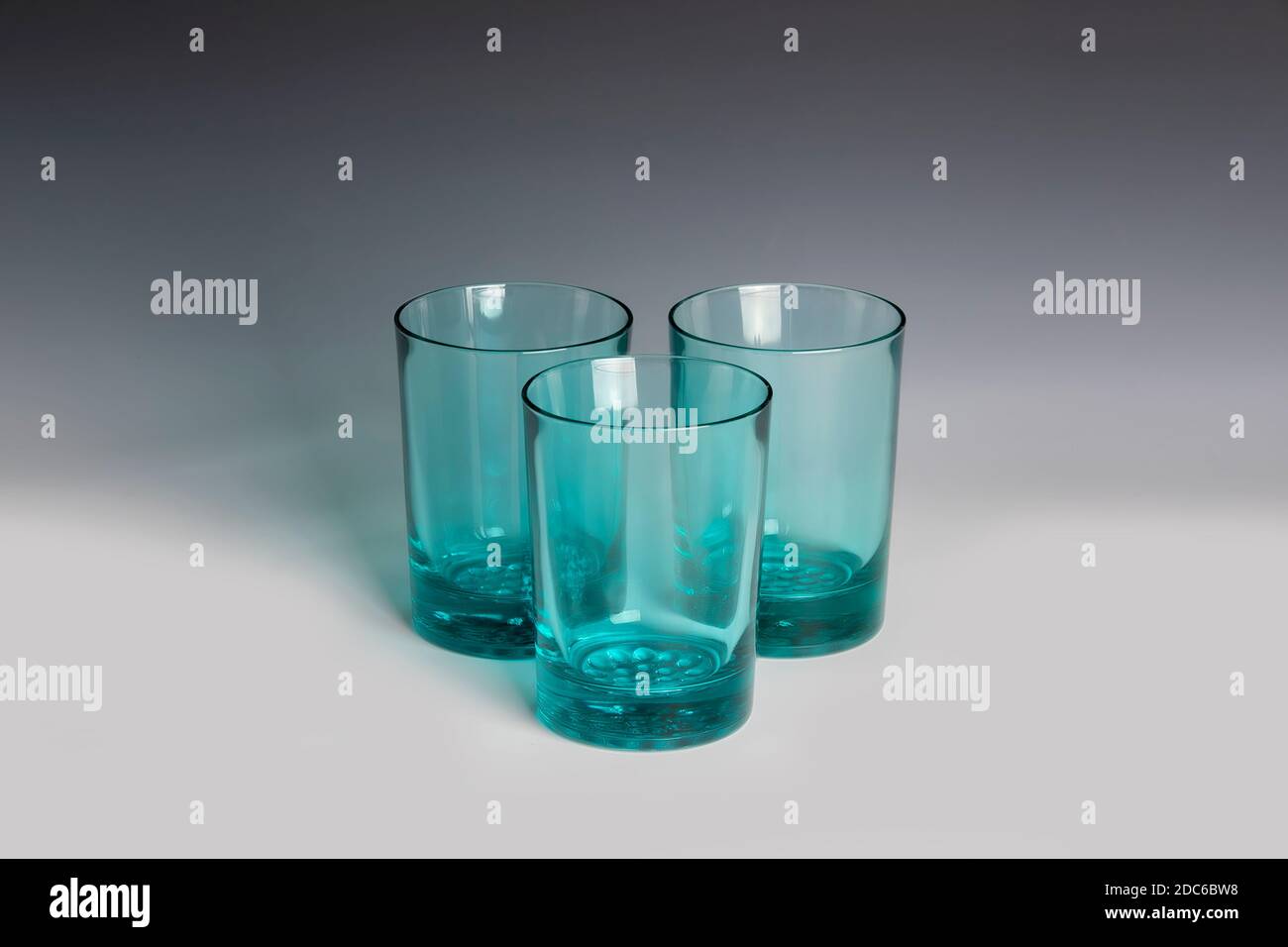 Still life Green glass tumblers on a graduated backdrop Stock Photo Alamy