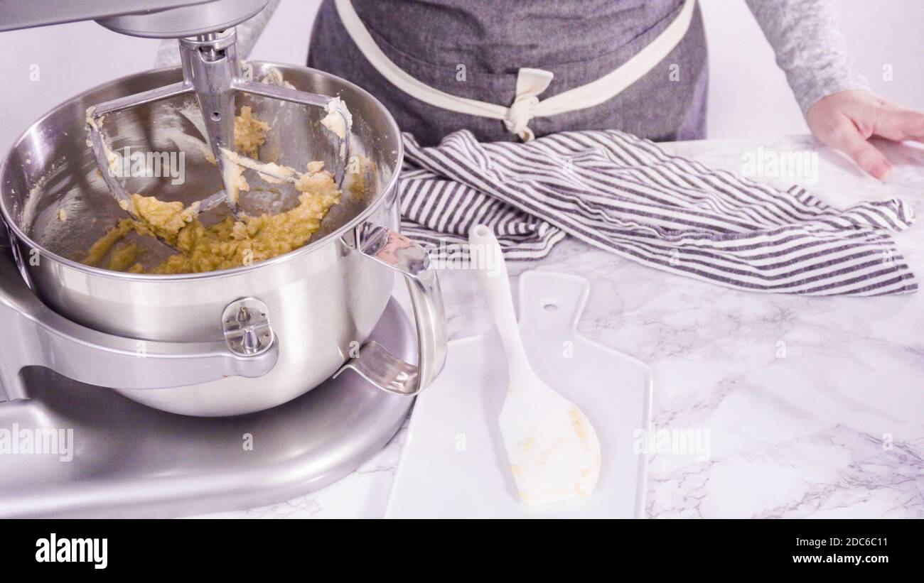 Step by step. Mixing ingredients in standing electric mixer for baking