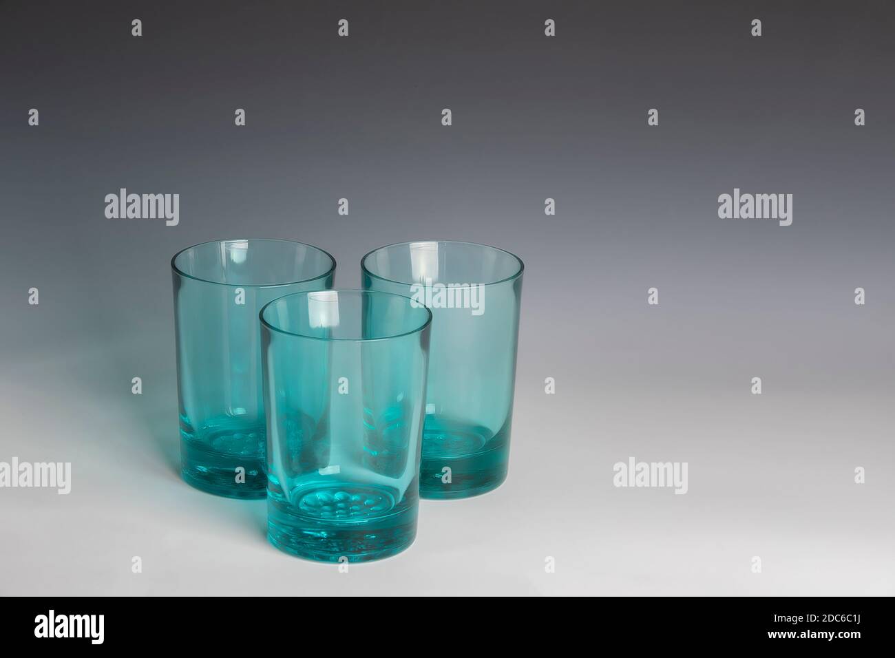 Still life Green glass tumblers on a graduated backdrop Stock Photo Alamy