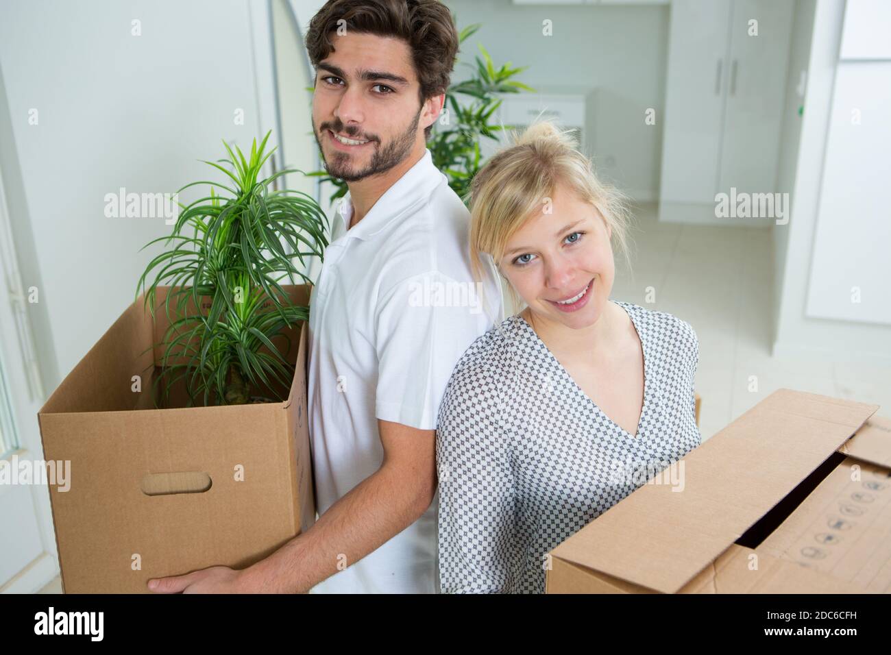 couple moving into new home and unpacking boxes Stock Photo - Alamy