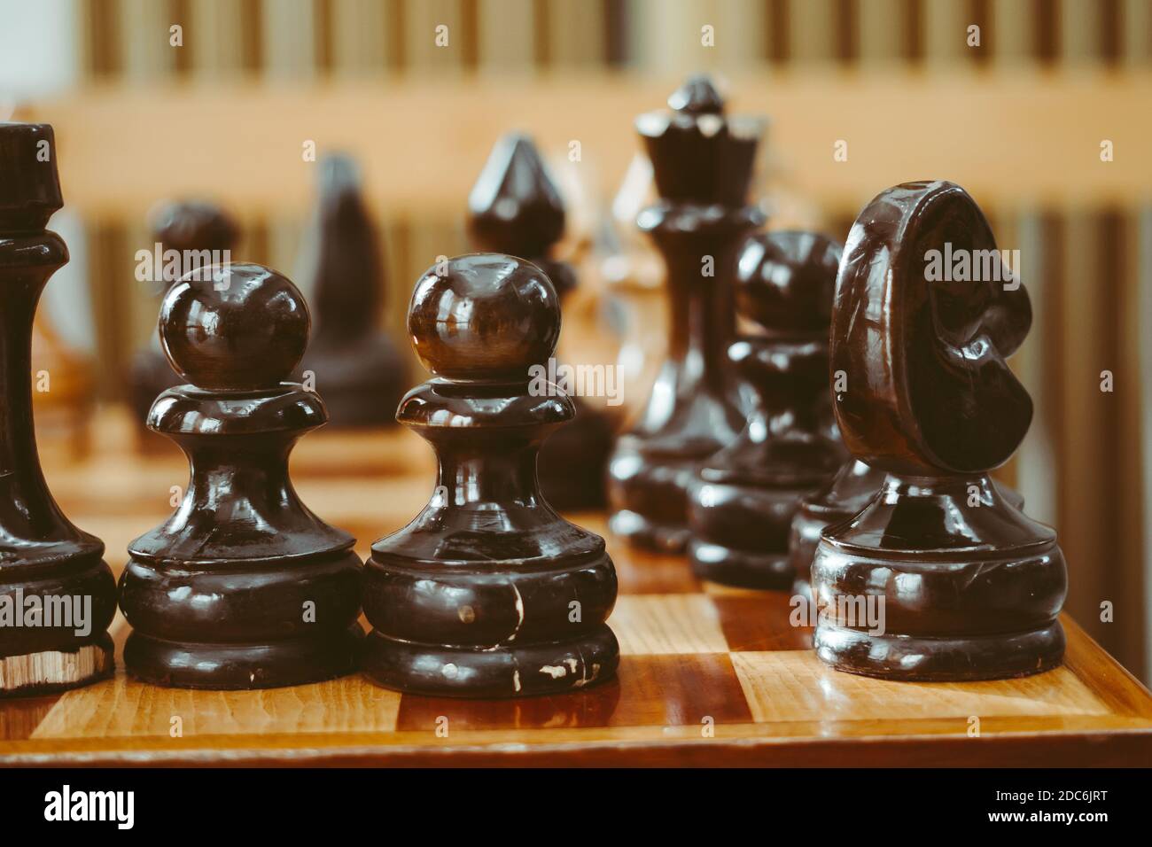 hand holding a large chess piece over the Board Stock Photo - Alamy