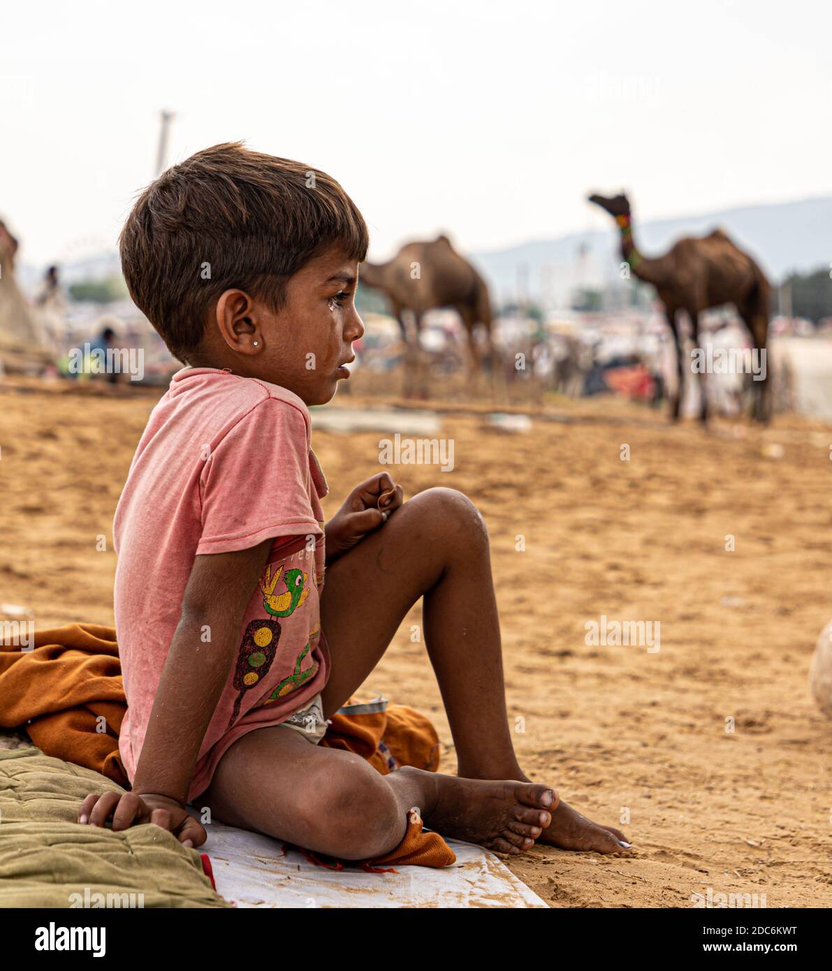 a little rajasthani boy is crying at camel fair of pushkar. Stock Photo