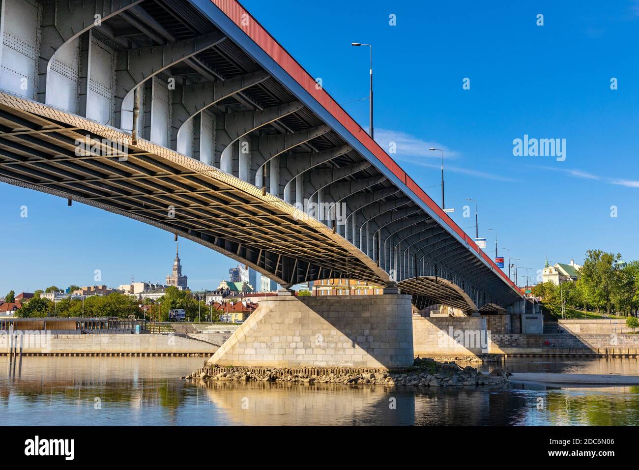 Warsaw, Mazovia / Poland - 2020/05/09: Most Slasko-Dabrowski bridge over Vistula river with Srodmiescie city center at Wybrzeze Kosciuszkowskie embank Stock Photo