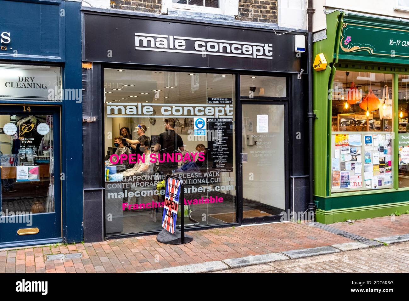 Local People Having Their Hair Cut At A Barber’s Shop, High Street