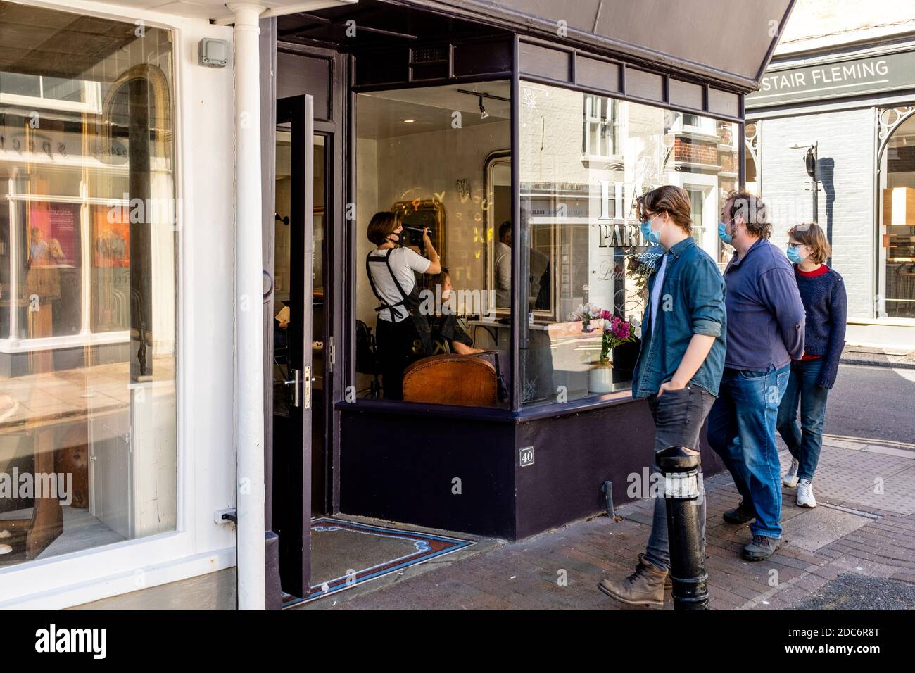 Local People Wearing Face Masks Queue Outside A Hairdresser’s Shop, High Street, Lewes, East
