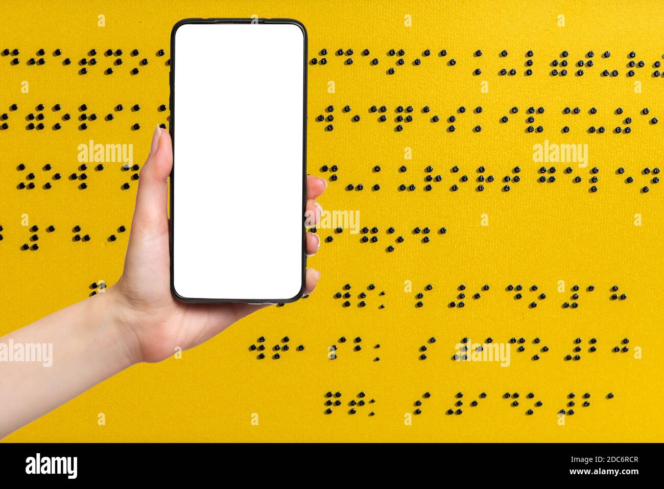 International day of the blind. A woman's hand holds a smartphone, with