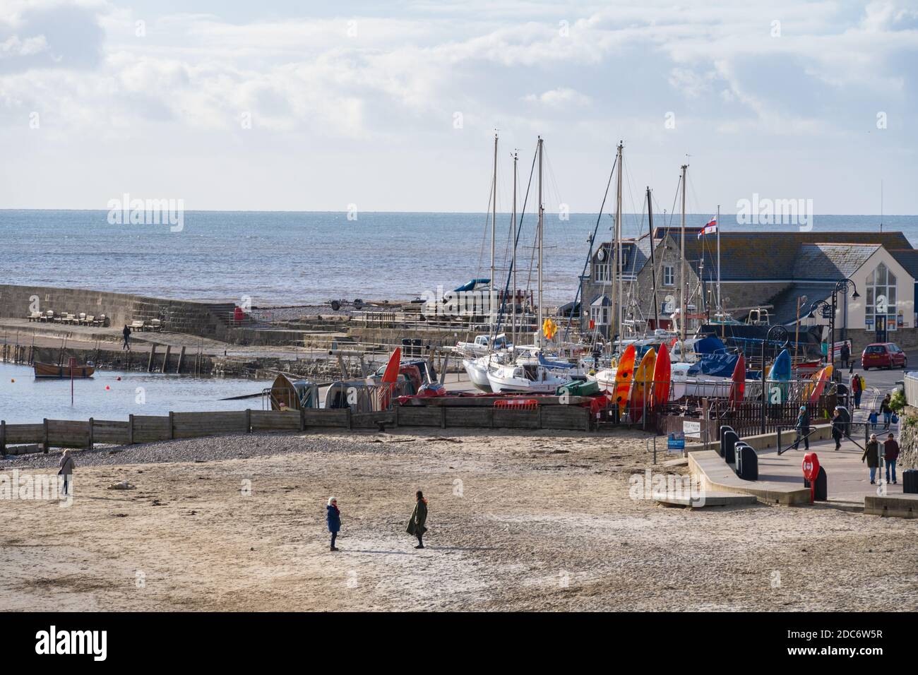 Lyme Regis, Dorset, UK. 19th Nov, 2020. UK Weather: Bright sunny spells at the seaside resort of Lyme Regis. Locals enjoy a brief respite from the dull and wet weather. Credit: Celia McMahon/Alamy Live News Stock Photo