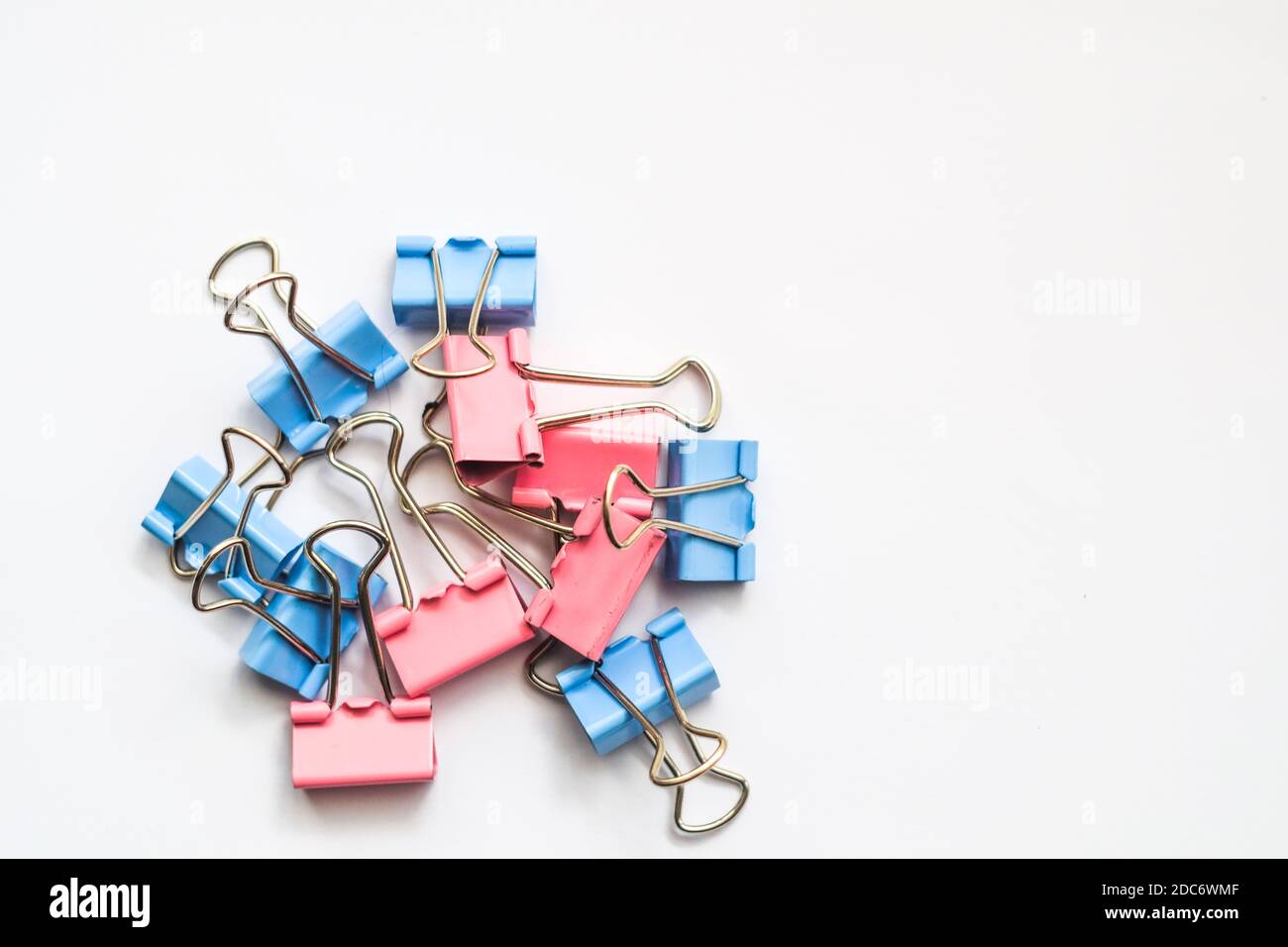 Colored iron paper clips. paper clips with many unique pastel color variants isolated on a white background, Binder clip is a simple device for bindin Stock Photo