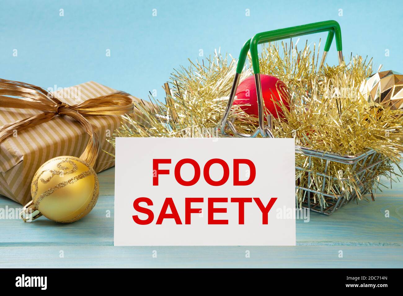 Shopping basket and text FOOD SAFETY on white paper note list. Shopping