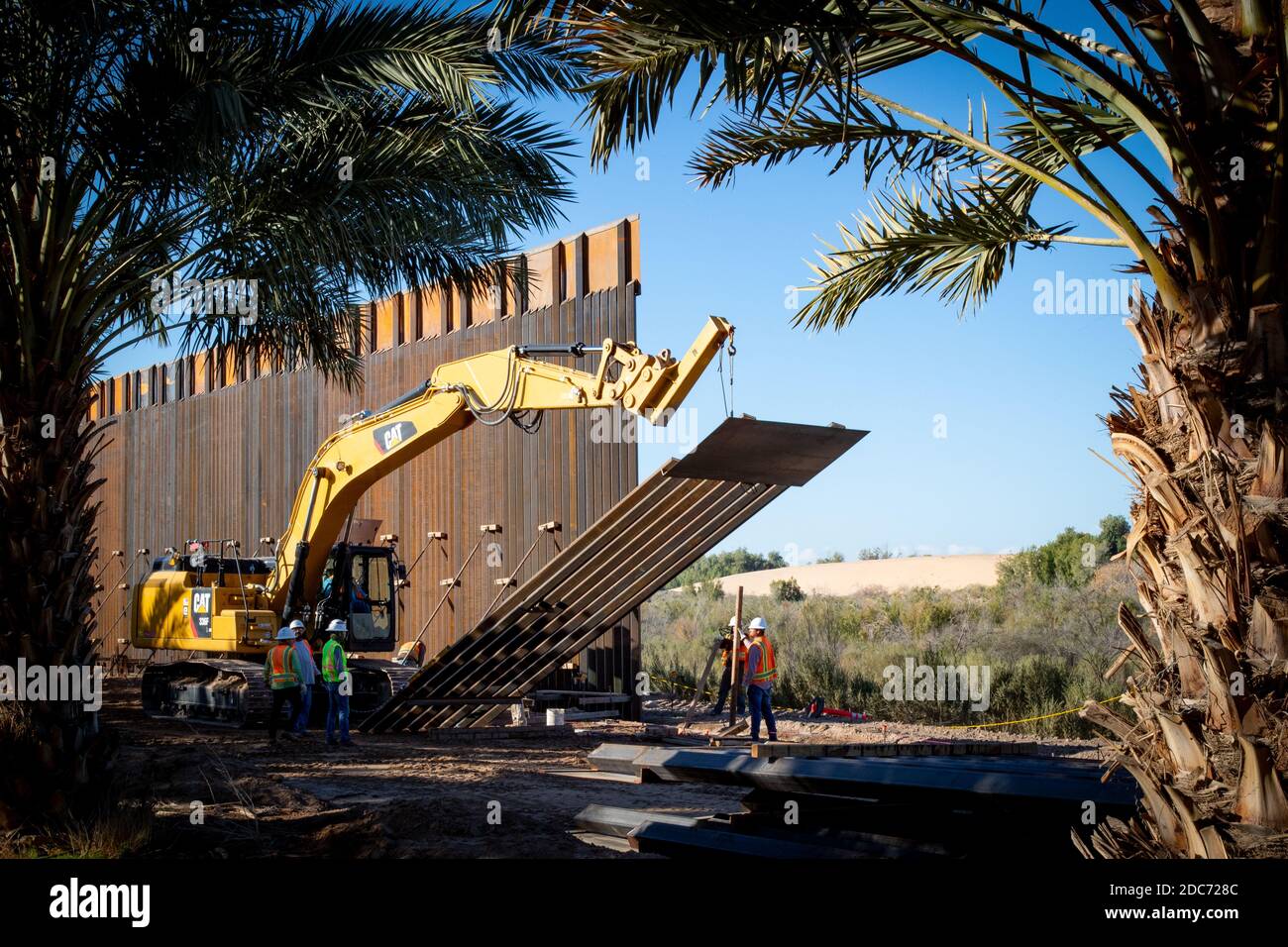 New 30-foot sections of bollard panels are lifted into place at a build site for the Tucson Sector of the U.S. - Mexican border wall, known at the Trump Wall January 9, 2020 near Yuma, Arizona. Stock Photo
