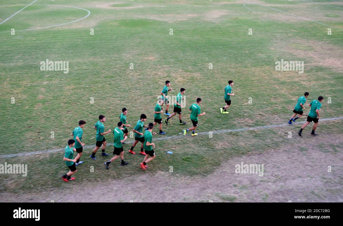 Amateur soccer team worming up in field Stock Photo
