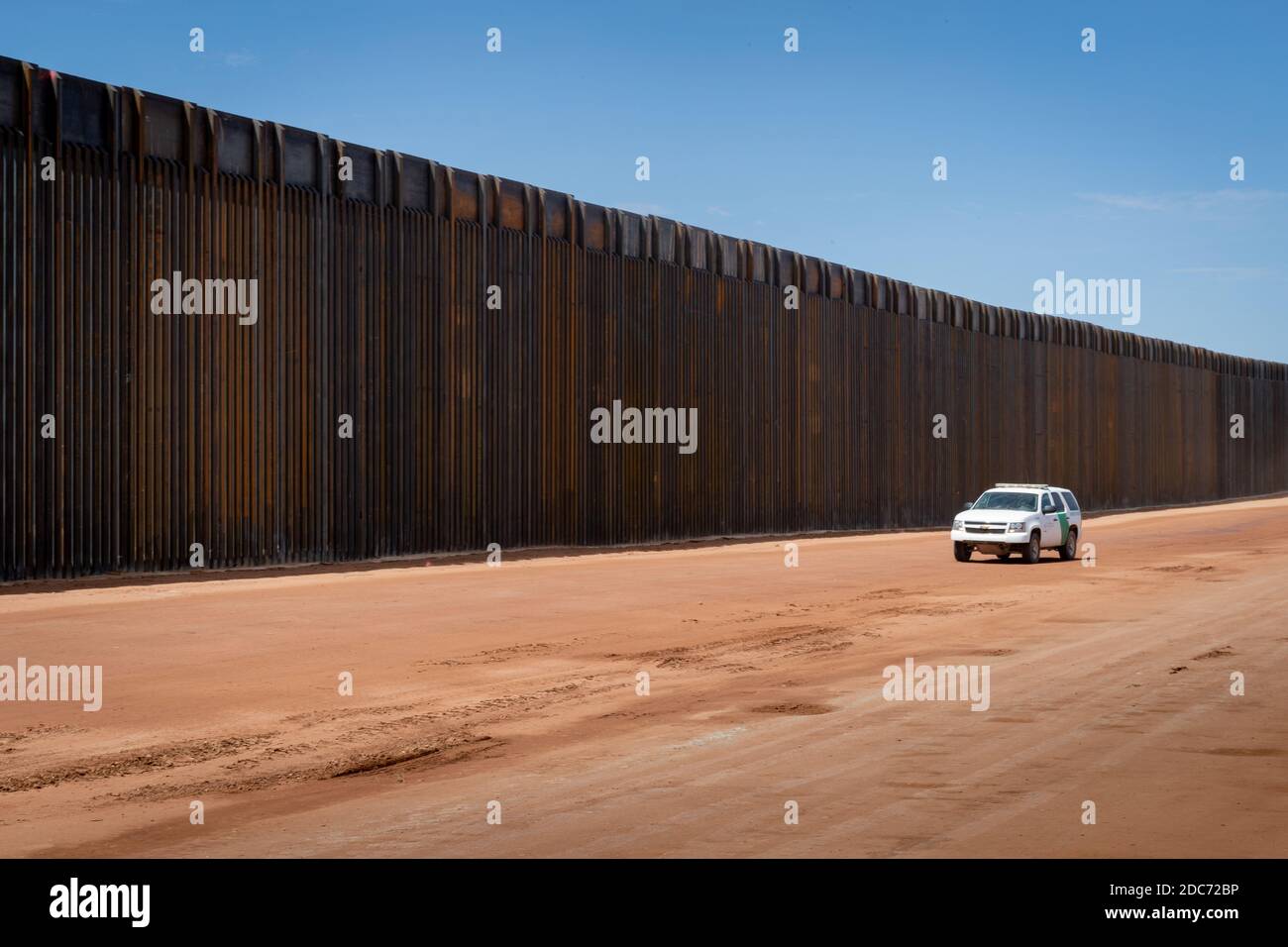 Customs and Border Protection officers patrol a new section of bollard panels along the Tucson Sector of the U.S. - Mexican border wall, known at the Trump Wall August 12, 2020 near Naco, Arizona. Stock Photo