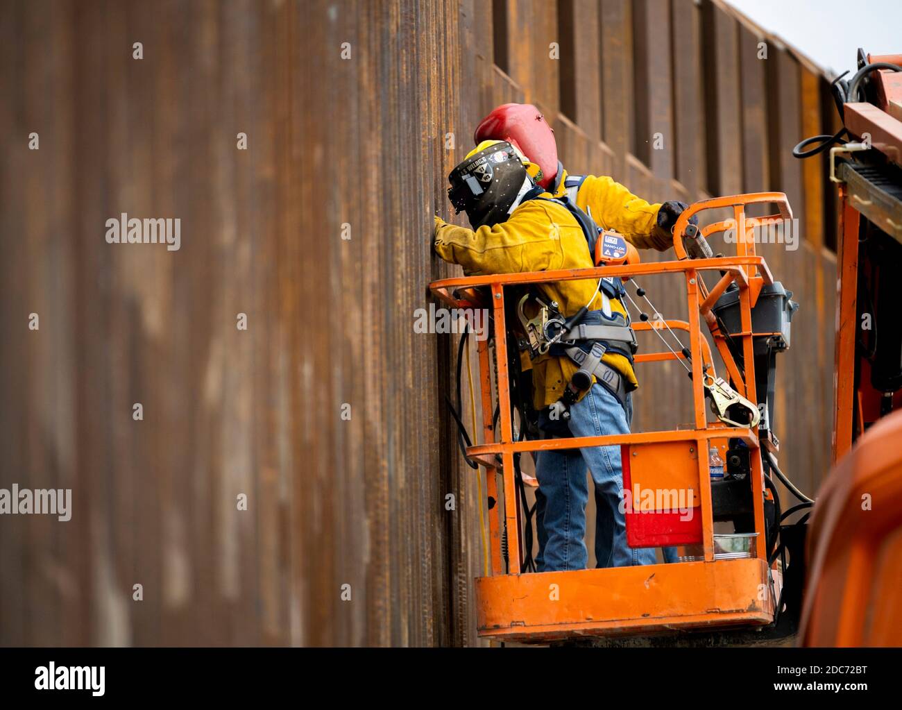 Construction workers weld anti-climb barriers at a build site for a section of the U.S. - Mexican border wall, known at the Trump Wall October 28, 2020 near McAllen, Texas. Stock Photo