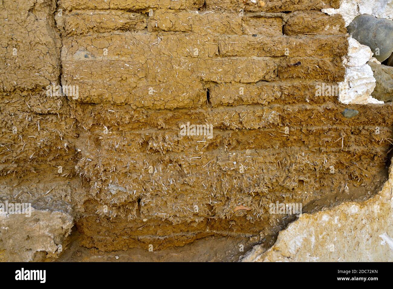 Old handmade clay and straw mud bricks exposed in wall Stock Photo