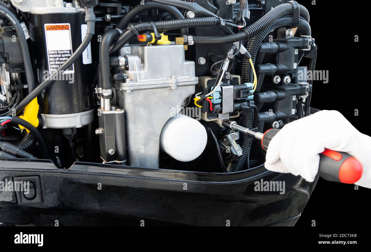Repairing outboard marine engine. Motorboat engine seasonal service and