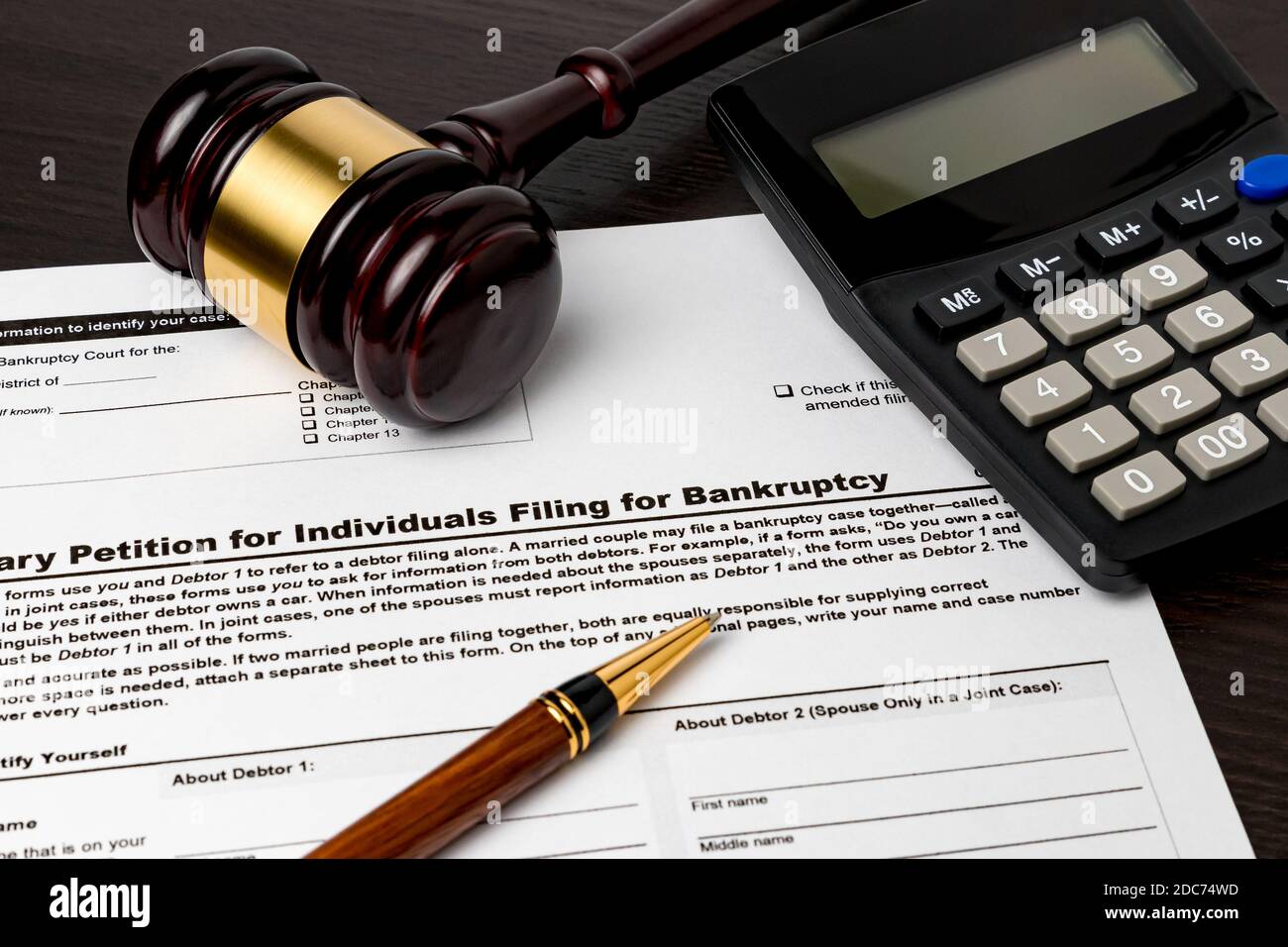 Bankruptcy petition for individuals with calculator and gavel. Concept of financial and unemployment crisis, personal debt, economy and recession. Stock Photo