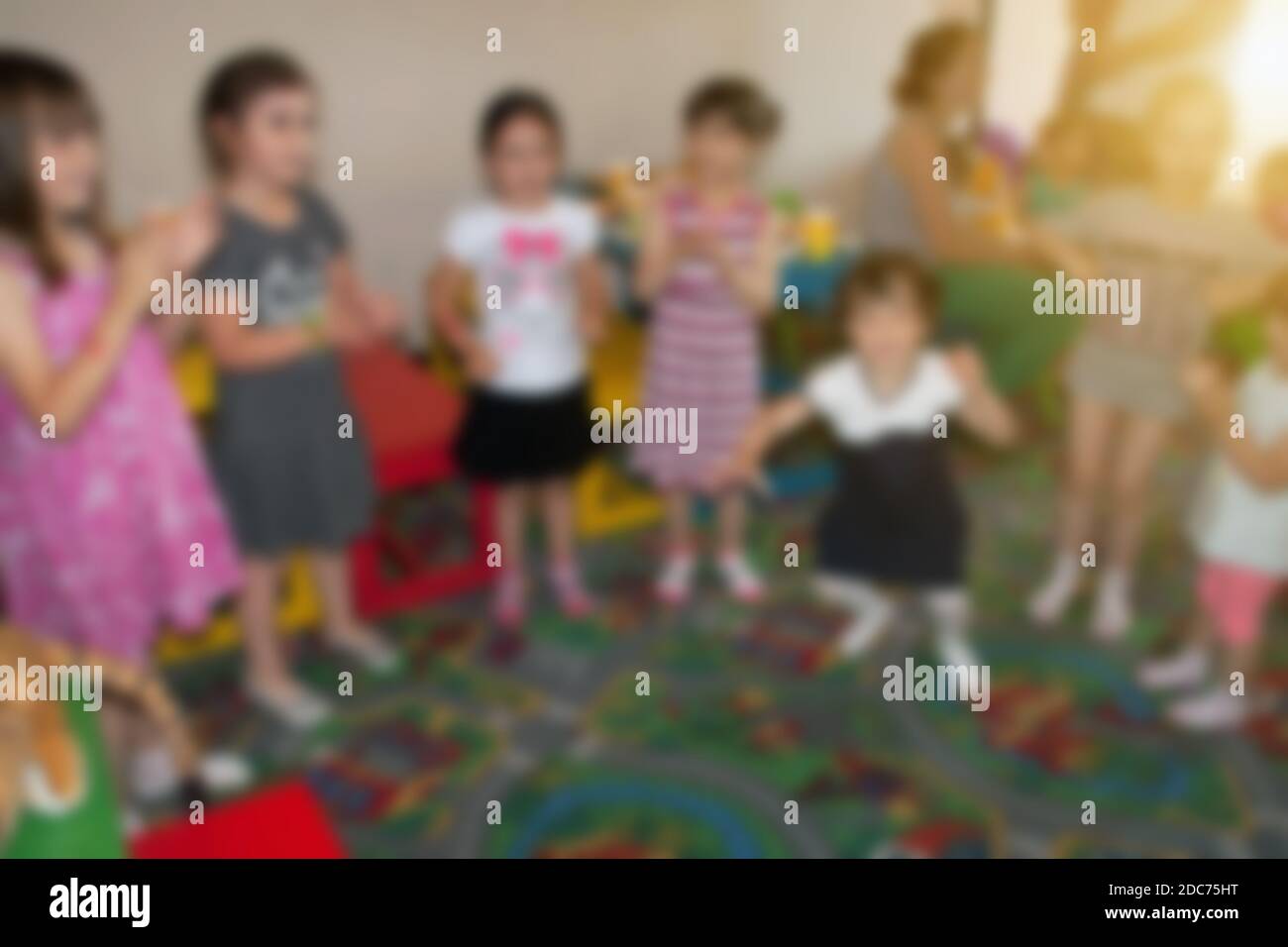 Dancing kids at birthday party in kindergarten. Blurred image for background use. Stock Photo