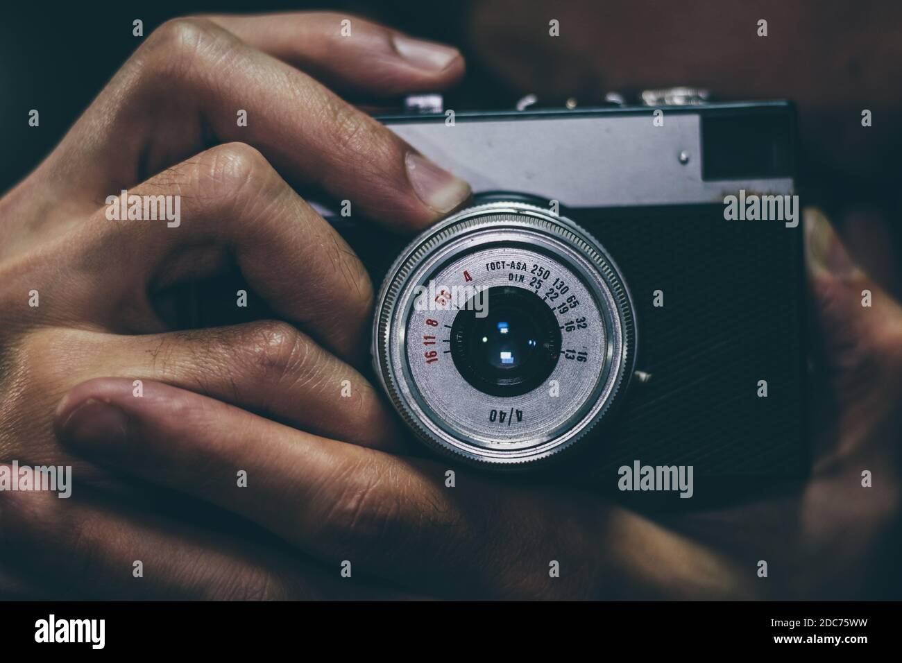 Man taking a photo with an old vintage film camera, close up. Stock Photo