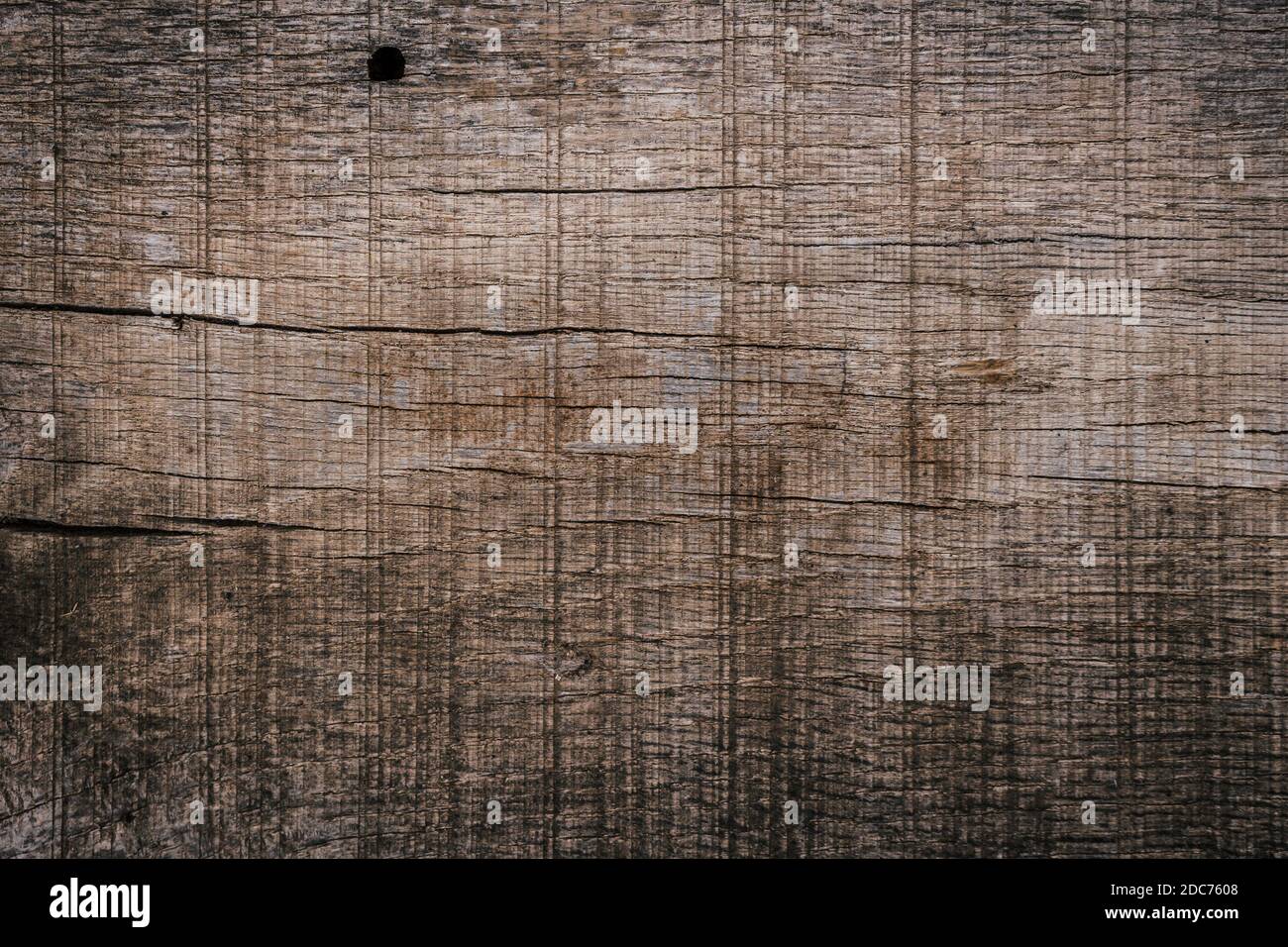 Texture of an old wooden plank with lots of cracks, scratches and holes. Close up. Stock Photo