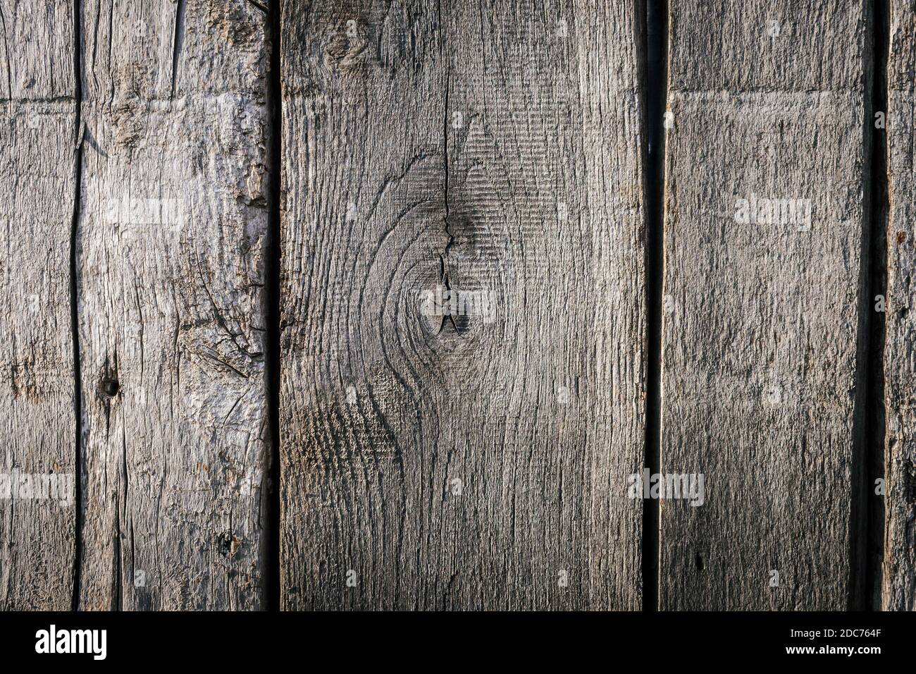 Texture of old wooden planks with lots of cracks, scratches and holes. Close up. Stock Photo