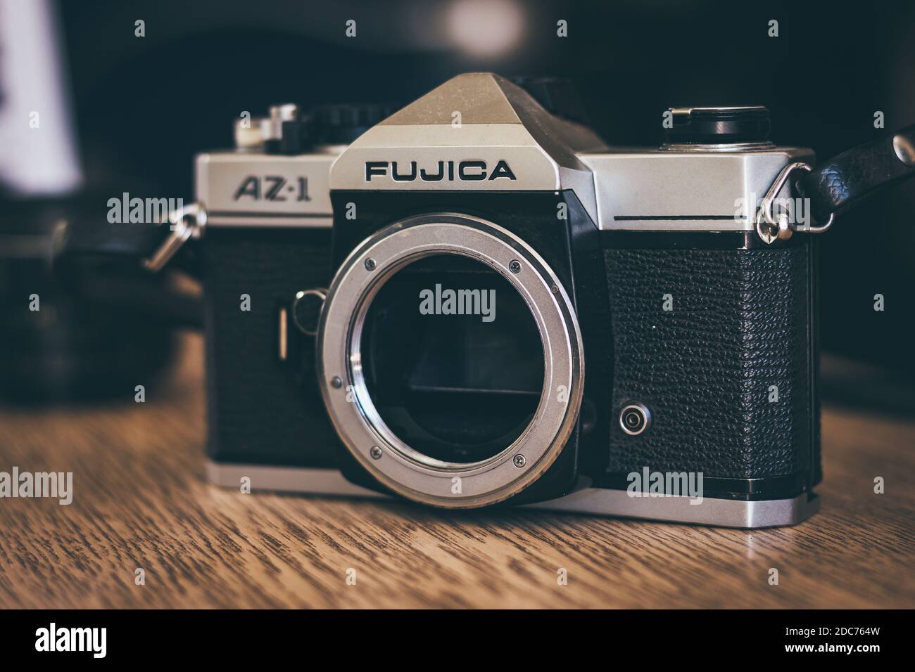 Old vintage Japanese film camera on wooden table. Model Fujica AZ1