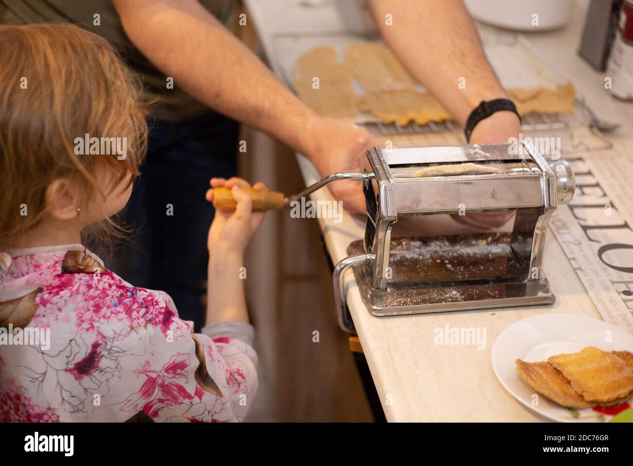 Daughter and father baking together Stock Photo