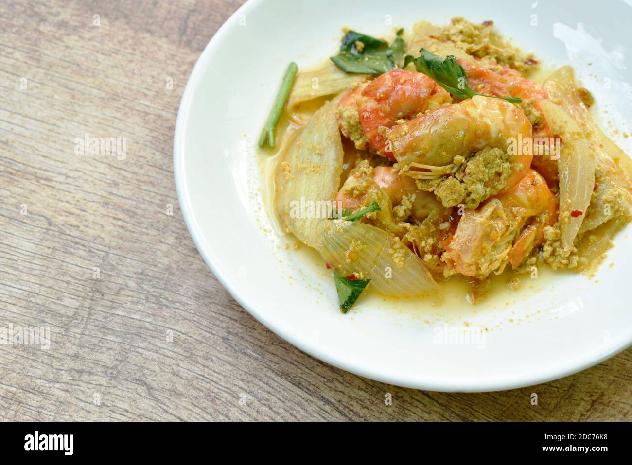 stirfried shrimp with egg and yellow curry on dish Stock Photo Alamy