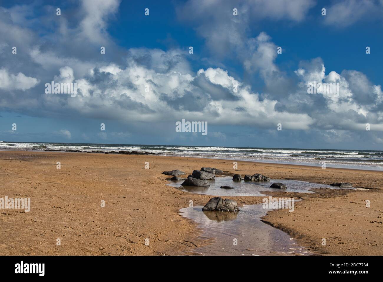 Rockpool on a Sandy Beach Stock Photo