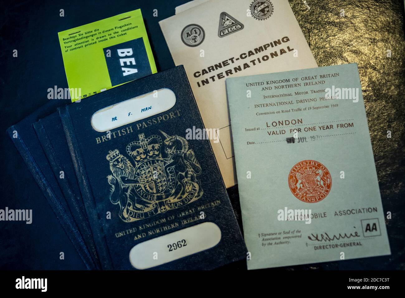 BEA, British European Airways, flight ticket (copy) inside old dark blue or black British passport and international driving permits, on briefcase Stock Photo