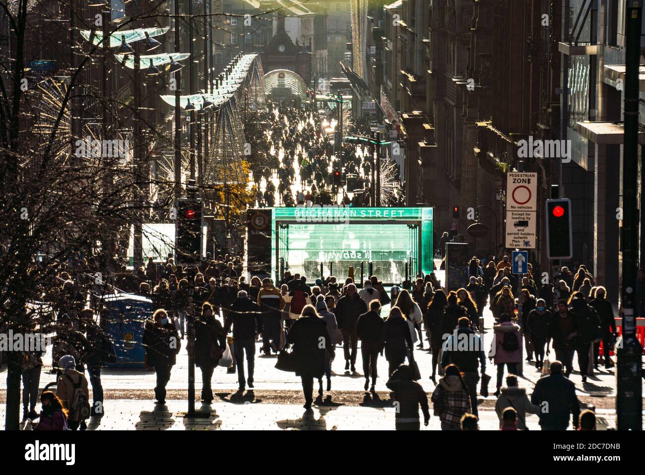 Glasgow, Scotland, UK. 19 November 2020. On the day before the highest level 4 lockdown is imposed on west and central Scotland, shops in Glasgow city centre and streets are busy with members of the public. Pictured; Crowds of shoppers in afternoon sunshine on Buchanan Street.  Iain Masterton/Alamy Live News Stock Photo