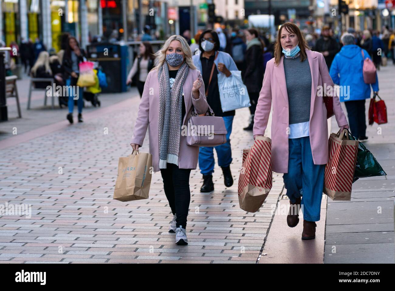 Glasgow, Scotland, UK. 19 November 2020. On the day before the highest level 4 lockdown is imposed on west and central Scotland, shops in Glasgow city centre and streets are busy with members of the public. Pictured; Women shopping on Argyle Street.  Iain Masterton/Alamy Live News Stock Photo
