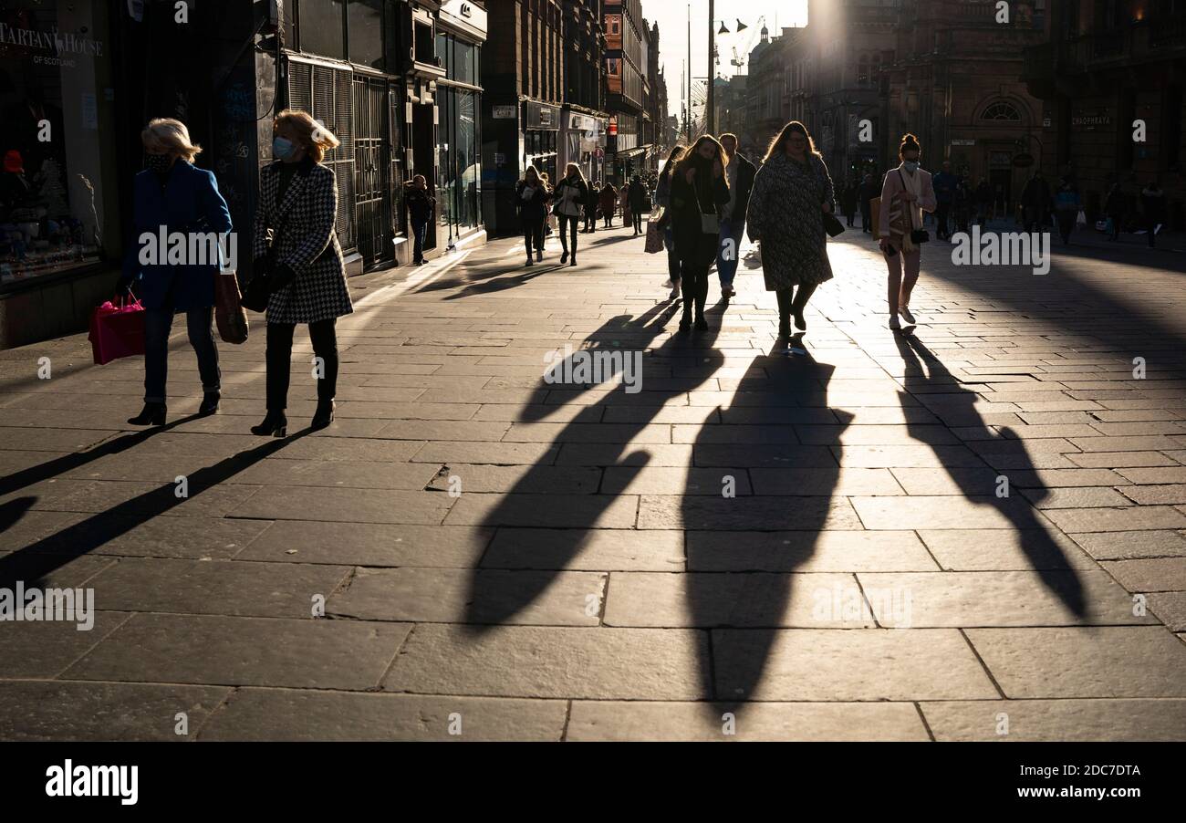 Glasgow, Scotland, UK. 19 November 2020. On the day before the highest level 4 lockdown is imposed on west and central Scotland, shops in Glasgow city centre and streets are busy with members of the public. Pictured; Shadows of shoppers on Buchanan Street.  Iain Masterton/Alamy Live News Stock Photo