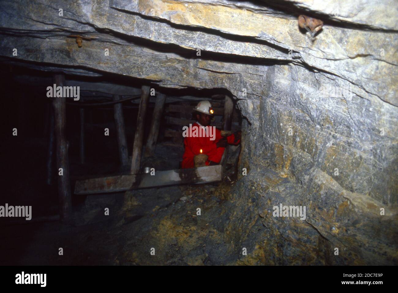 Worker in cramped conditions demonstrating how mining had once been carried out by candle-light, Gold Mine Museum, Johannesburg, South Africa 1981 Stock Photo