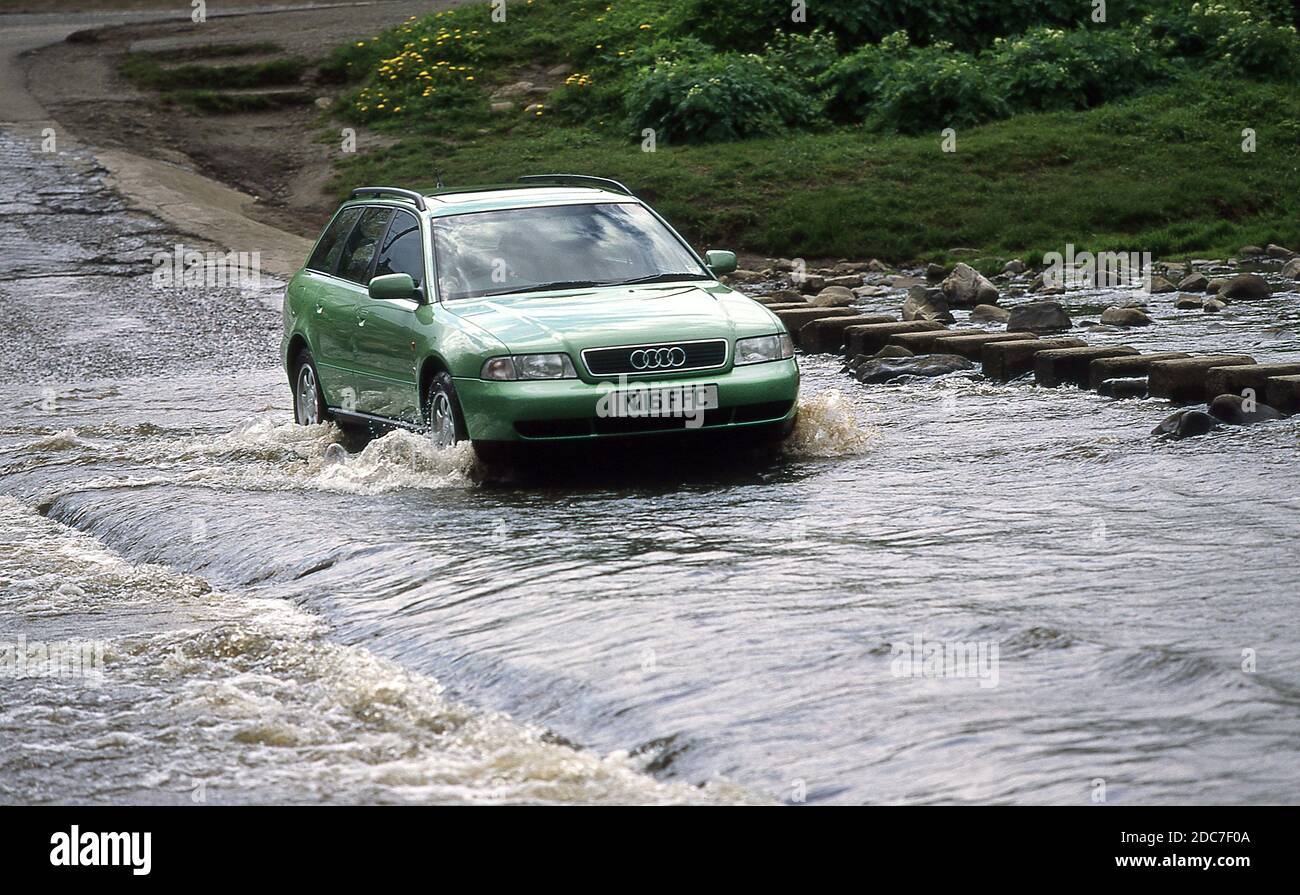 Driving through a river Ford in a 1996 Audi A4 Avant Stock Photo