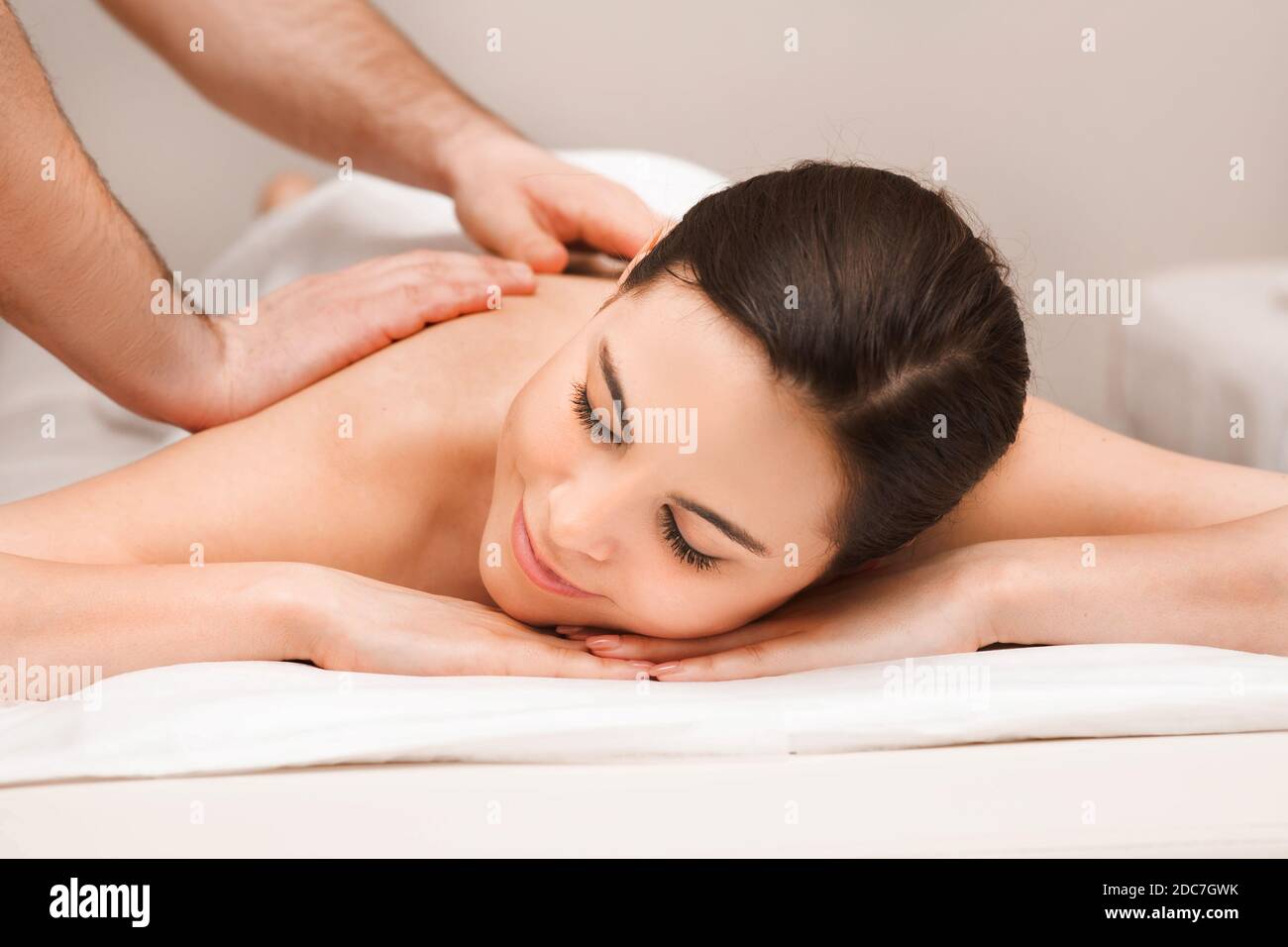 Thai back massage, mixed race woman during a relaxing massage. Anti-stress massage at wellness spa resort Stock Photo
