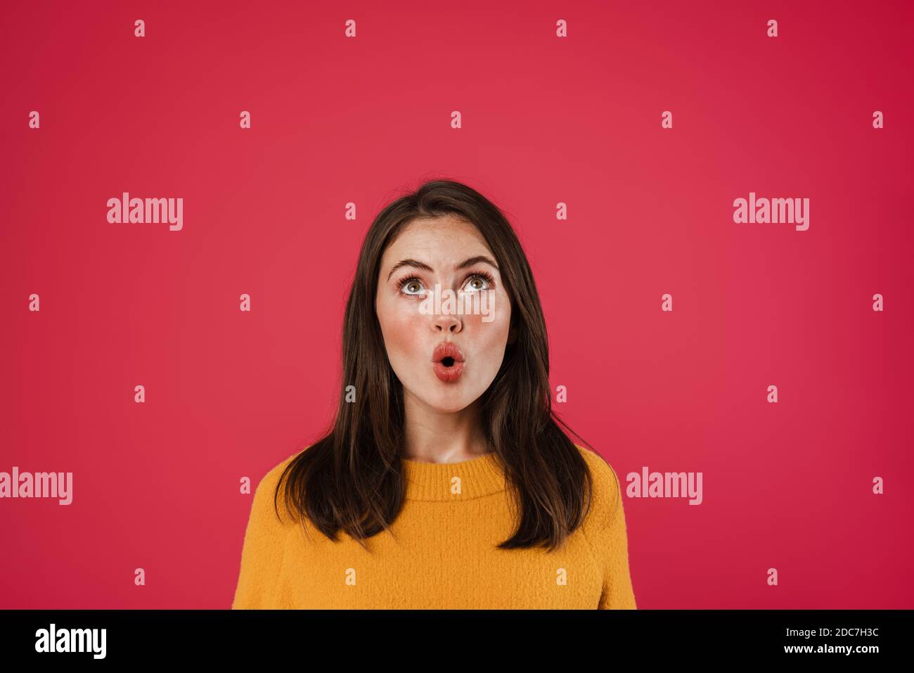 Image of surprised beautiful girl posing and looking upward isolated ...