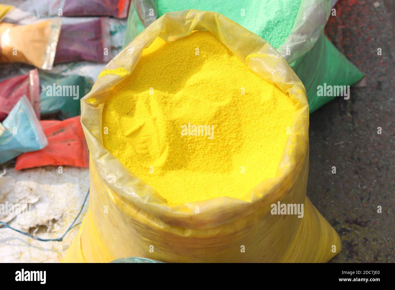In this shot artisan is demonstrating on road, Rangoli art by using a ...