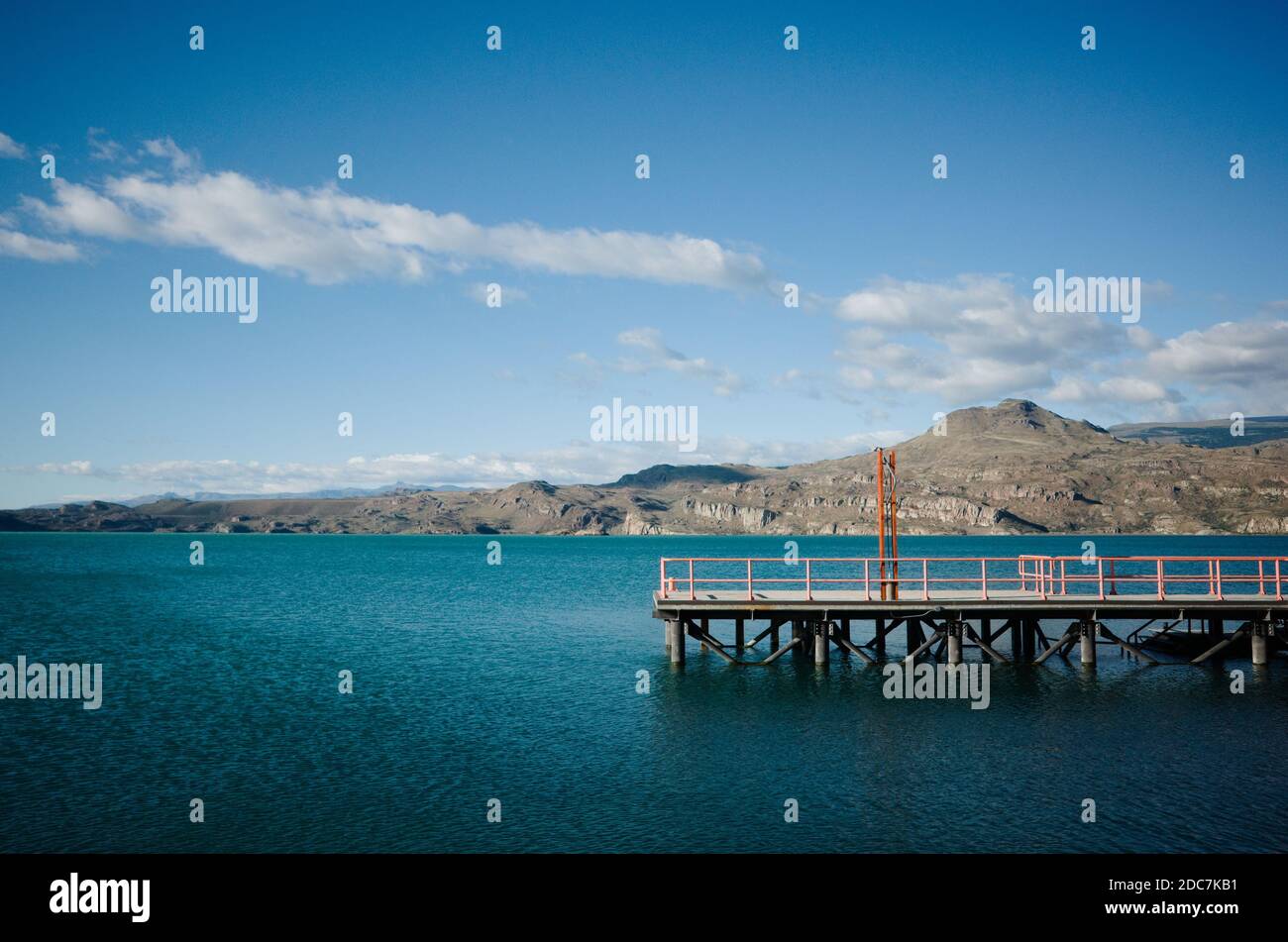 Ferry pier on the lake called Lago General Carrera in small town Puerto Ibanez in Chile. Chilean Patagonia view of glacial lake water against mountain Stock Photo