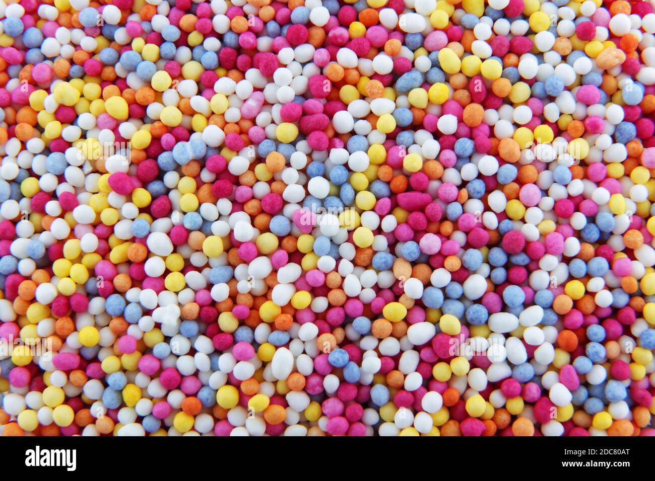 hundreds and thousands sprinkles tiny sugar beads for decorating cakes and desserts background texture Stock Photo